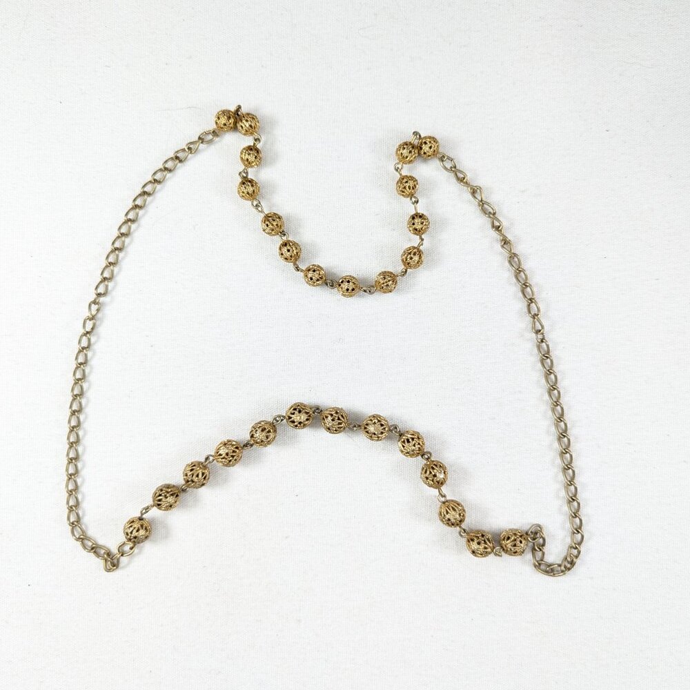 Gold toned filigree ball necklace